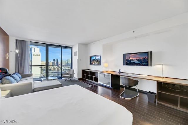 bedroom featuring access to exterior, hardwood / wood-style floors, and expansive windows