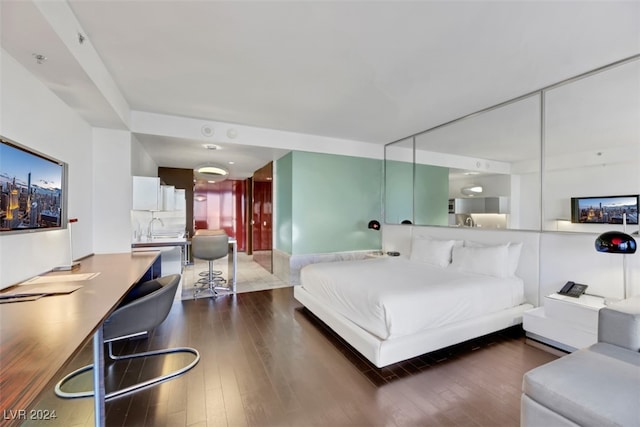 bedroom featuring hardwood / wood-style floors and sink