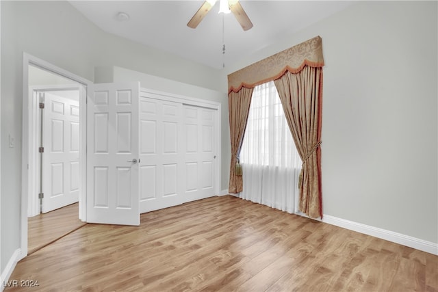 unfurnished bedroom with light hardwood / wood-style floors, a closet, and ceiling fan