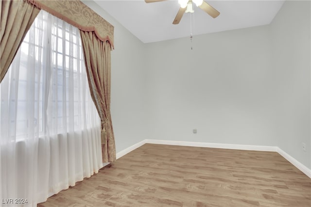 spare room with ceiling fan and light wood-type flooring