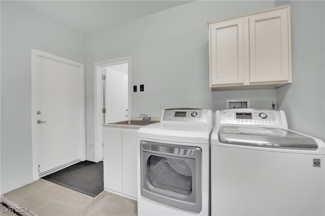 washroom with sink, cabinets, and independent washer and dryer