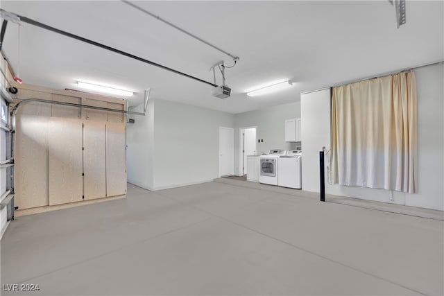 garage featuring a garage door opener and independent washer and dryer