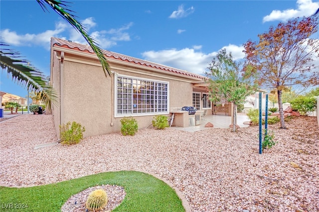 rear view of property featuring a patio area