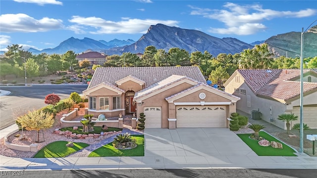 view of front facade featuring a mountain view, a garage, and cooling unit