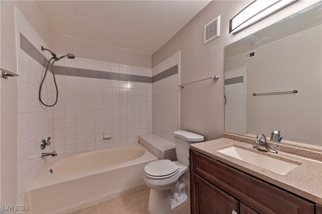 full bathroom featuring tile patterned flooring, vanity, tiled shower / bath combo, and toilet