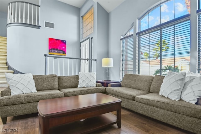 living room featuring hardwood / wood-style flooring and a high ceiling