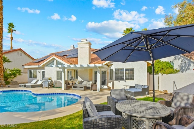 back of house with a pergola, an outdoor living space, a patio, and solar panels