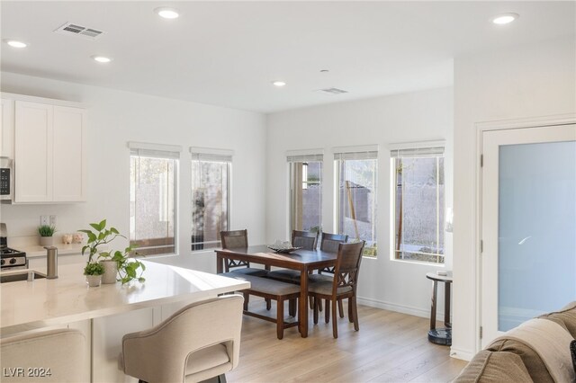 dining space featuring light wood-type flooring