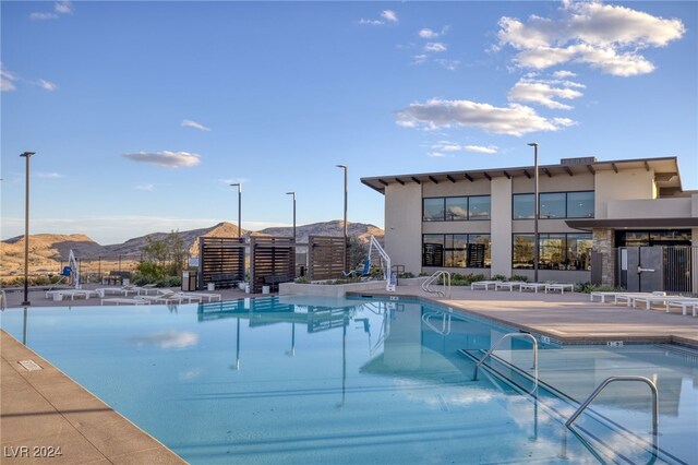 view of swimming pool with a mountain view and a patio