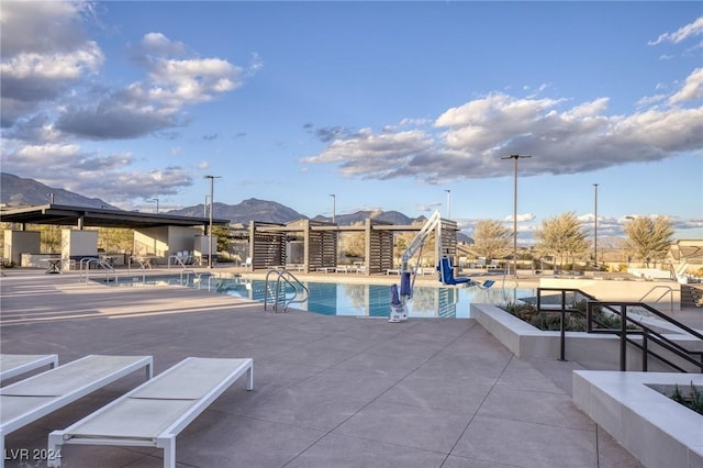 view of pool with a mountain view and a patio