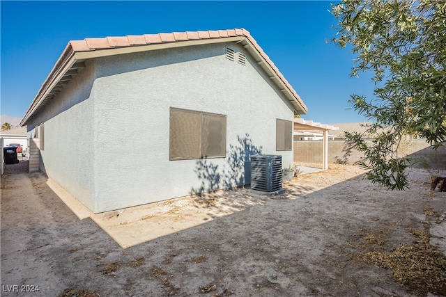 back of property featuring central air condition unit