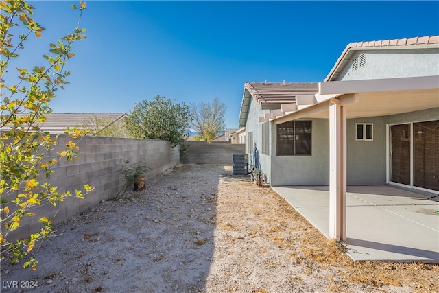 view of yard featuring central air condition unit and a patio area