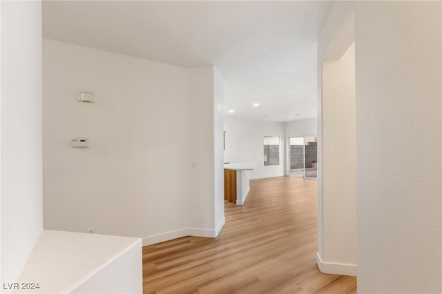 corridor with light hardwood / wood-style floors