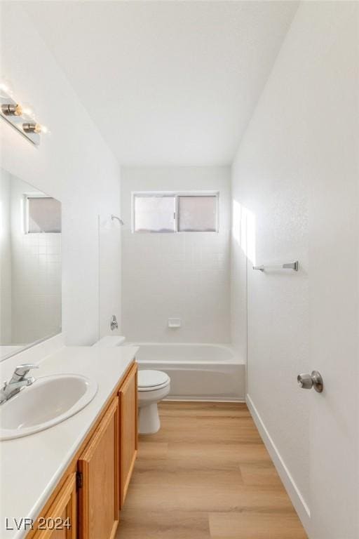 bathroom featuring shower / bath combination, baseboards, toilet, wood finished floors, and vanity