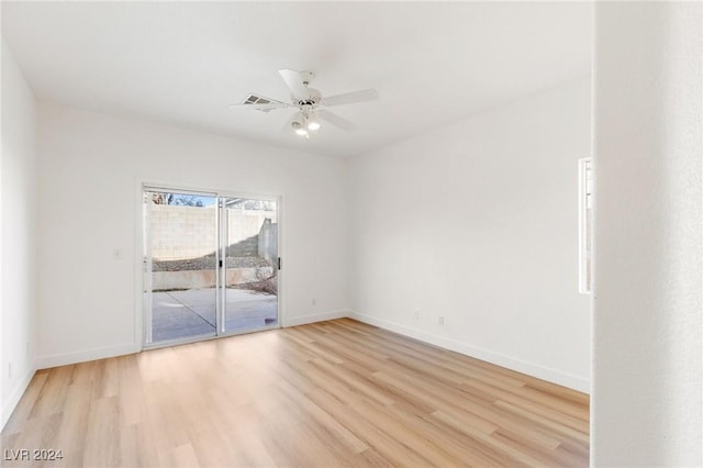 unfurnished room with a ceiling fan, light wood-style flooring, and baseboards