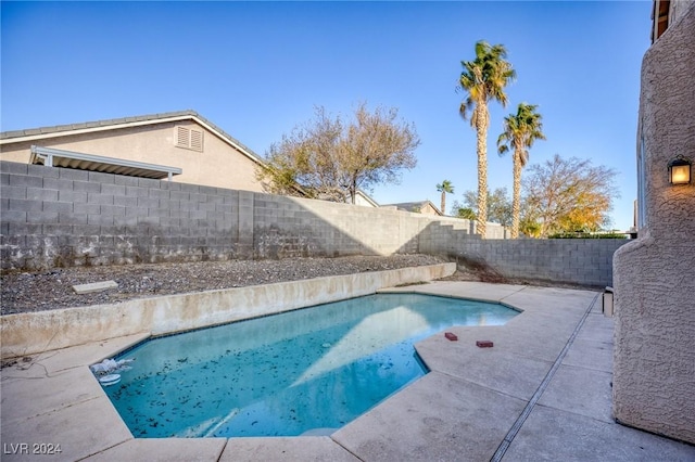 view of swimming pool featuring a patio area, a fenced backyard, and a fenced in pool