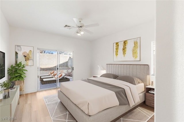 bedroom featuring access to exterior, light wood finished floors, and a ceiling fan