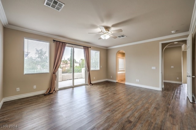 empty room featuring dark hardwood / wood-style flooring, ceiling fan, and ornamental molding