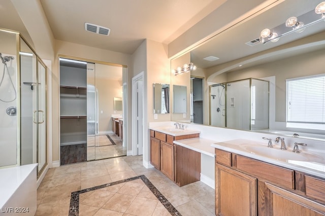 bathroom featuring vanity, tile patterned flooring, and plus walk in shower