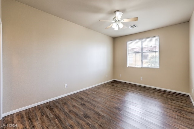 spare room with ceiling fan and dark hardwood / wood-style floors