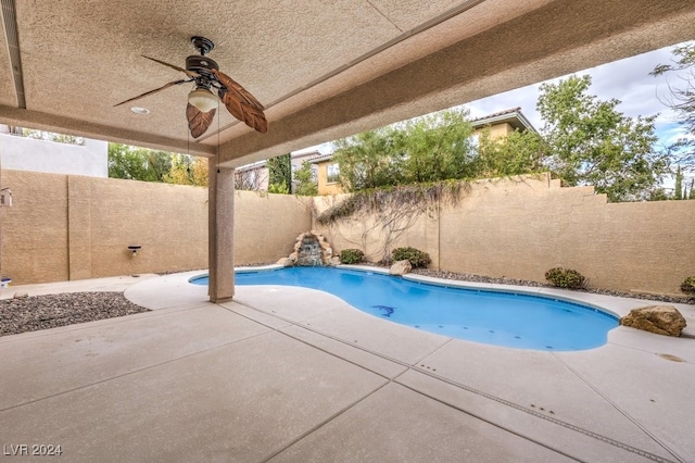 view of swimming pool featuring ceiling fan and a patio