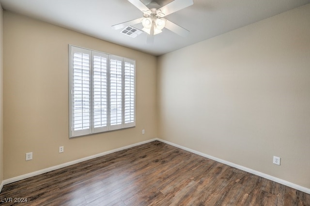 spare room with ceiling fan and dark wood-type flooring