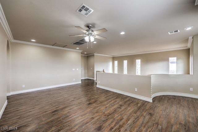 spare room with a wealth of natural light, ceiling fan, dark wood-type flooring, and ornamental molding