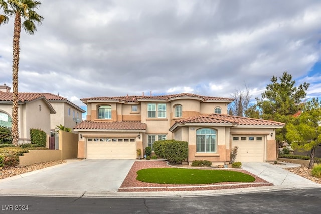 mediterranean / spanish-style house with a garage