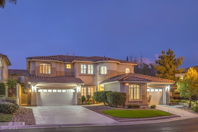 mediterranean / spanish home featuring a garage