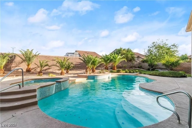 view of swimming pool with an in ground hot tub