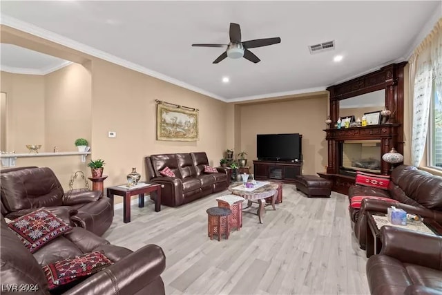 living room featuring crown molding, ceiling fan, and light wood-type flooring