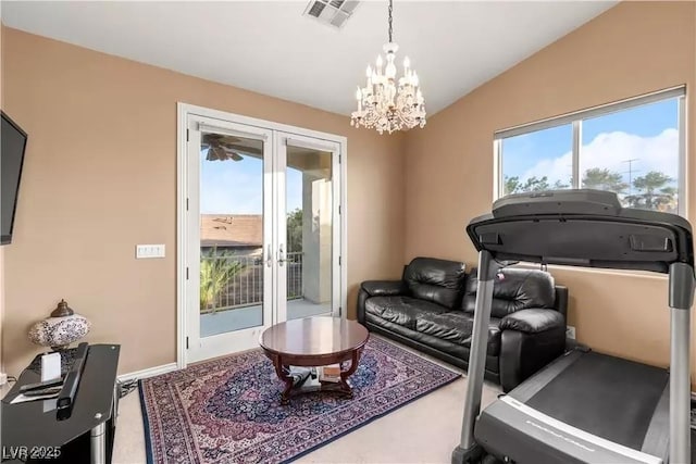 workout area featuring french doors, a notable chandelier, lofted ceiling, and plenty of natural light