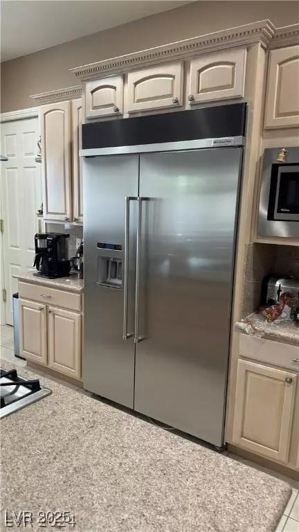 kitchen with stainless steel appliances, light tile patterned flooring, and decorative backsplash