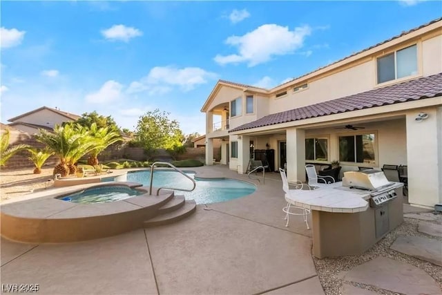 view of pool with area for grilling, a patio, and an in ground hot tub