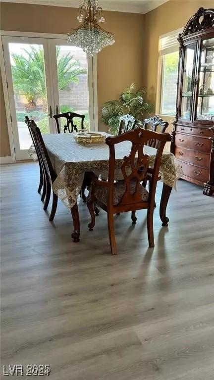 dining room with a chandelier and light hardwood / wood-style flooring