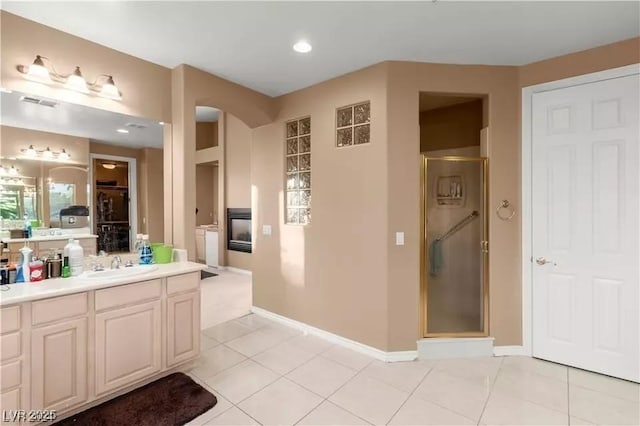 bathroom with vanity, tile patterned floors, and a shower with shower door