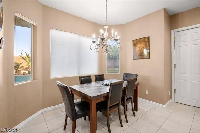 dining area with an inviting chandelier and light tile patterned flooring