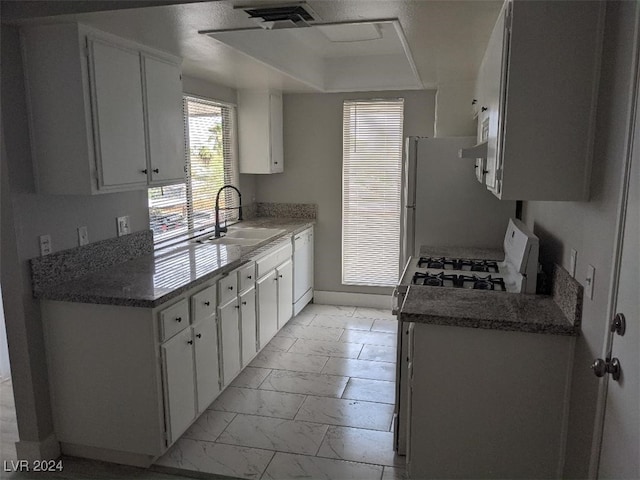 kitchen featuring white cabinets, white appliances, and sink