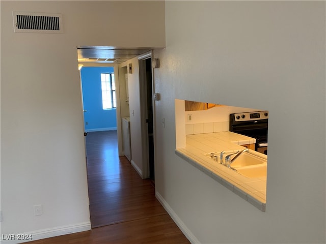 corridor featuring dark hardwood / wood-style flooring and sink