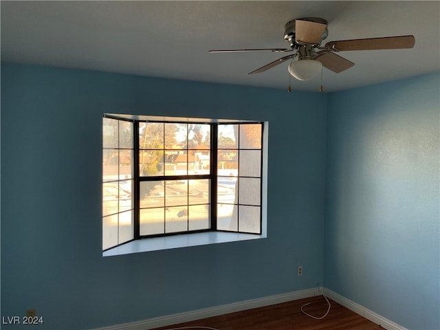 empty room featuring ceiling fan and hardwood / wood-style floors