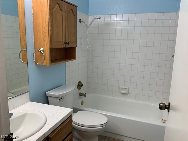 full bathroom with vanity, tiled shower / bath combo, and toilet