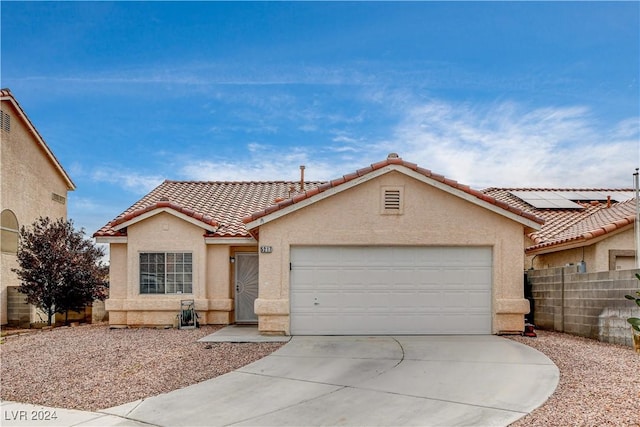 view of front of property featuring driveway, an attached garage, a tiled roof, and stucco siding