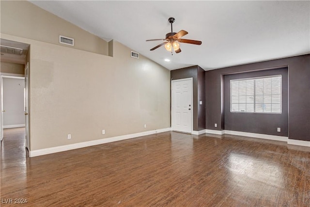 empty room featuring baseboards, visible vents, dark wood finished floors, lofted ceiling, and ceiling fan