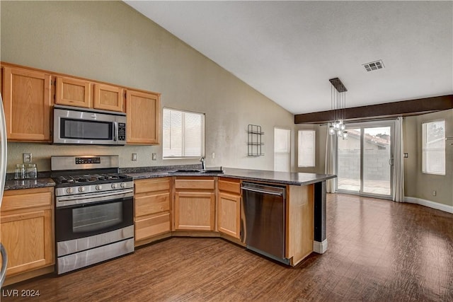 kitchen featuring visible vents, appliances with stainless steel finishes, hanging light fixtures, a peninsula, and a sink