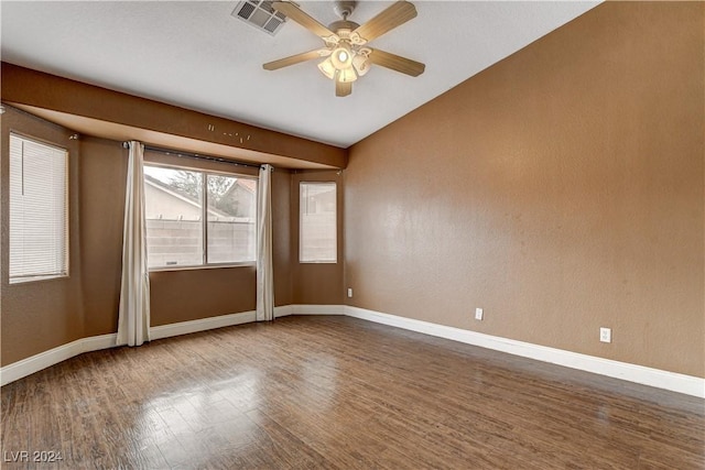 spare room featuring a ceiling fan, baseboards, visible vents, and wood finished floors