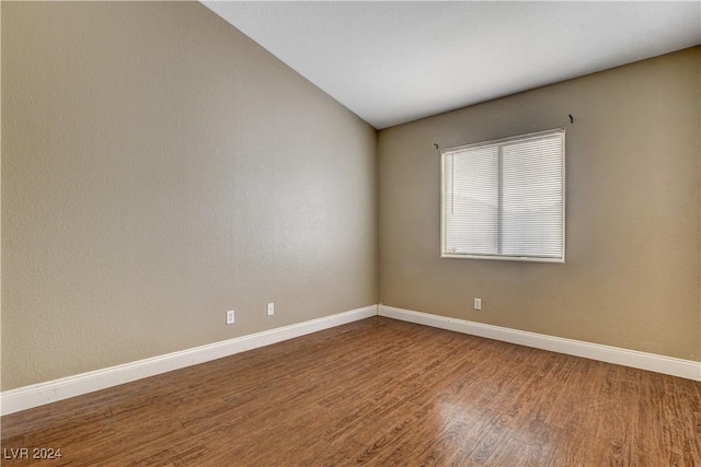 empty room with baseboards and wood finished floors