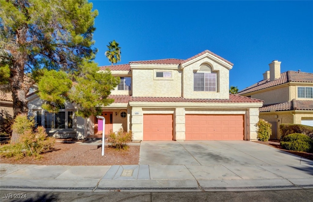 mediterranean / spanish-style house featuring a garage