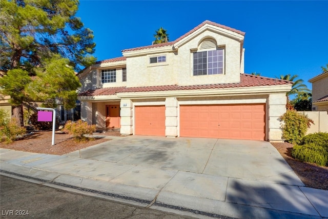 mediterranean / spanish home featuring a garage