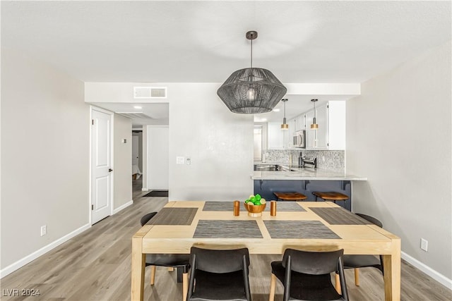 dining area with light hardwood / wood-style floors