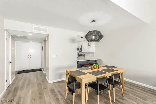 dining room with light hardwood / wood-style floors